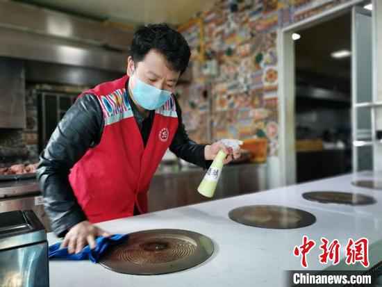 陈真做好备餐前期工作。 叶翠 摄 放弃“宅”生活 新疆餐厅老板为一线防疫人员当起“送餐员”